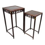 A graduated pair of early 20th century oriental hardwood tables - with a square panelled top above a