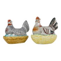 An early 20th century egg caddy - modelled in the form of a hen seated on a wicker nest, 21cm