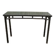 A Chinese dark stained altar style side table - the cleated panel top above an open frieze and
