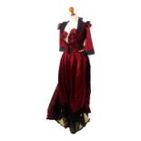 A late Victorian dress - possibly W L Hicks of 115 New Bond Street, of red floral satin with black