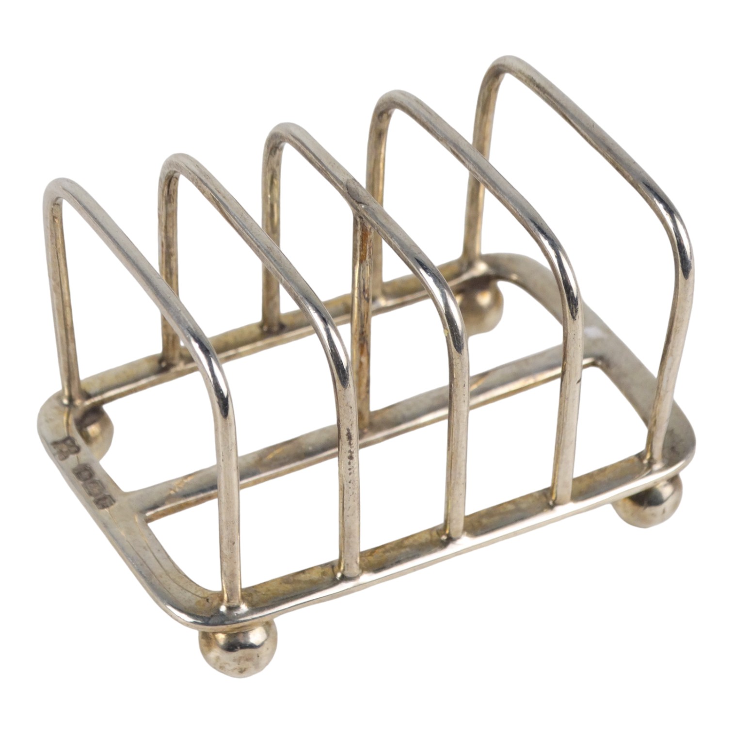 A small silver four division toast rack - Sheffield 1916, Martin Hall & Co Ltd, length 6.5cm, weight