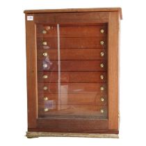 A mahogany collector's table cabinet - with a glazed panel door enclosing ten drawers