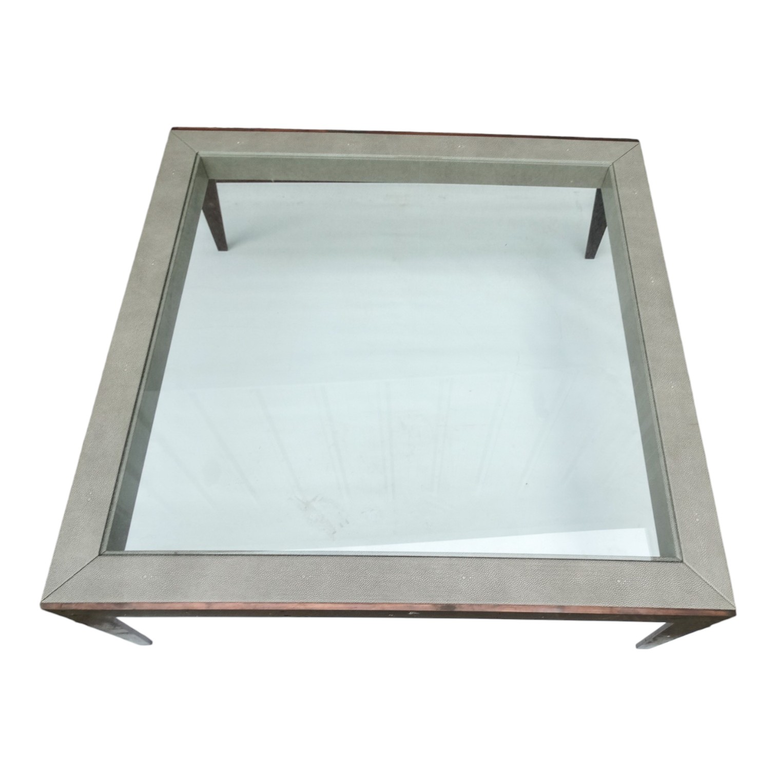 A contemporary glass and faux shagreen coffee table - square and raised on tapering profile bronze