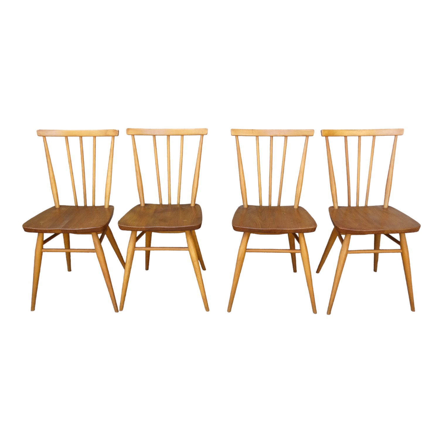 A set of four Ercol elm and beech chairs - with stick backs and contoured seats, on turned