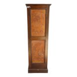 A large early 20th century oak collector's cabinet - with a tan leather panel door enclosing an