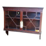 An Edwardian mahogany wall cabinet - with Greek key cornice above a pair of astragal doors enclosing