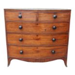 A George III mahogany bowfront chest of drawers, with an arrangement of two short and three long