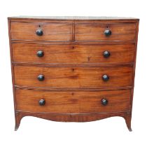 A George III mahogany bowfront chest of drawers, with an arrangement of two short and three long