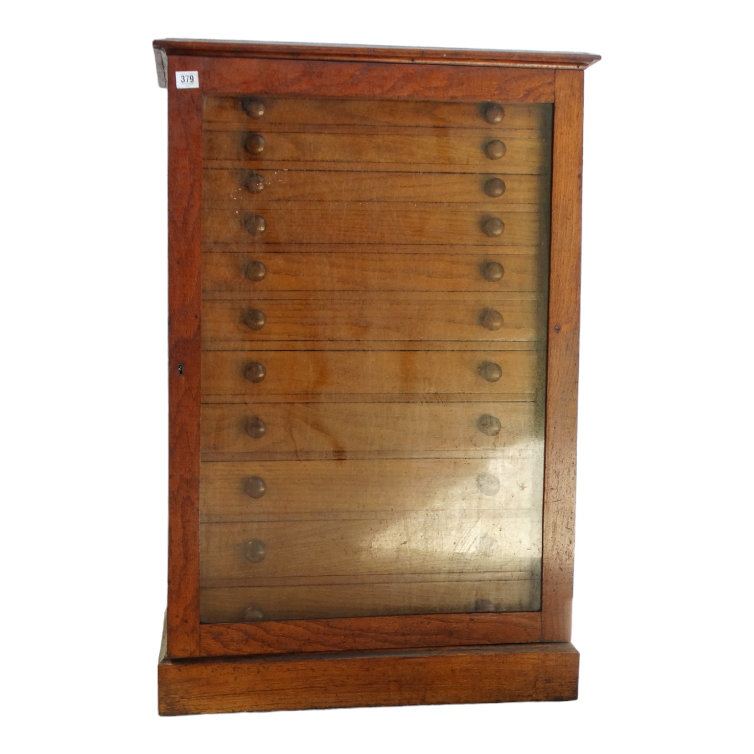A late 19th century collectors cabinet - with a glazed pane door enclosing eleven drawers