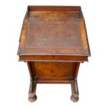 A Victorian walnut Davenport desk - with a three quarter gallery and scrolled supports,