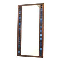 A vintage Danish wall mirror - the rosewood frame inset with two rows of blue tiles, 116cm high