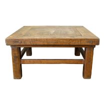 A late 19th century Chinese hardwood low table - cleated plank top and raised on square legs