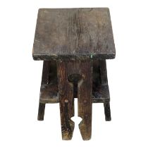 An early 20th century Arts & Crafts pine stool - with a square seat on pierced legs joined by an