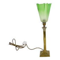 A brass table lamp - the fluted column on a stepped base with a Corinthian capital and a green glass