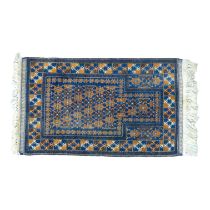 A Balouch prayer rug - the stepped central pane with boteh on a bule ground, 84 x 144cm.