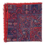 A wool shawl by Liberty - with a red and blue paisley pattern, 130 x 130cm.