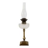 A late Victorian glass and brass oil lamp - with a cut glass reservoir raised on a column support