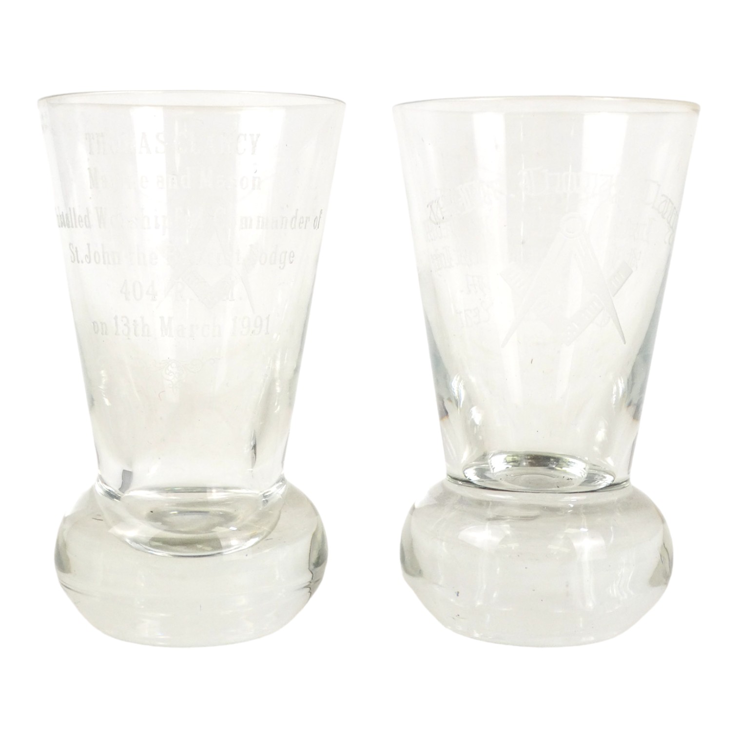 A pair of Freemasons centenary glasses - with etched decoration, height 11cm.