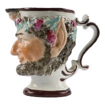 An early 19th century pearlware jug - modelled in the form of Bacchus, height 11cm.