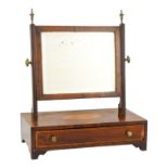 A 19th century mahogany toilet mirror - the rectangular plate between moulded supports, the base