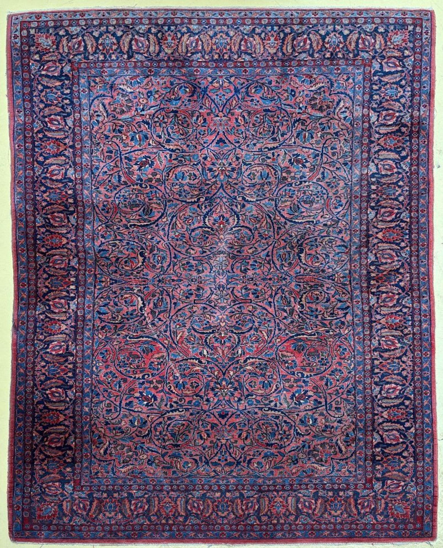 Persian rug with floral decoration on a red background