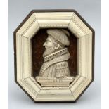 A carved relief in bone with octagonal frame 'portrait of a gentleman'