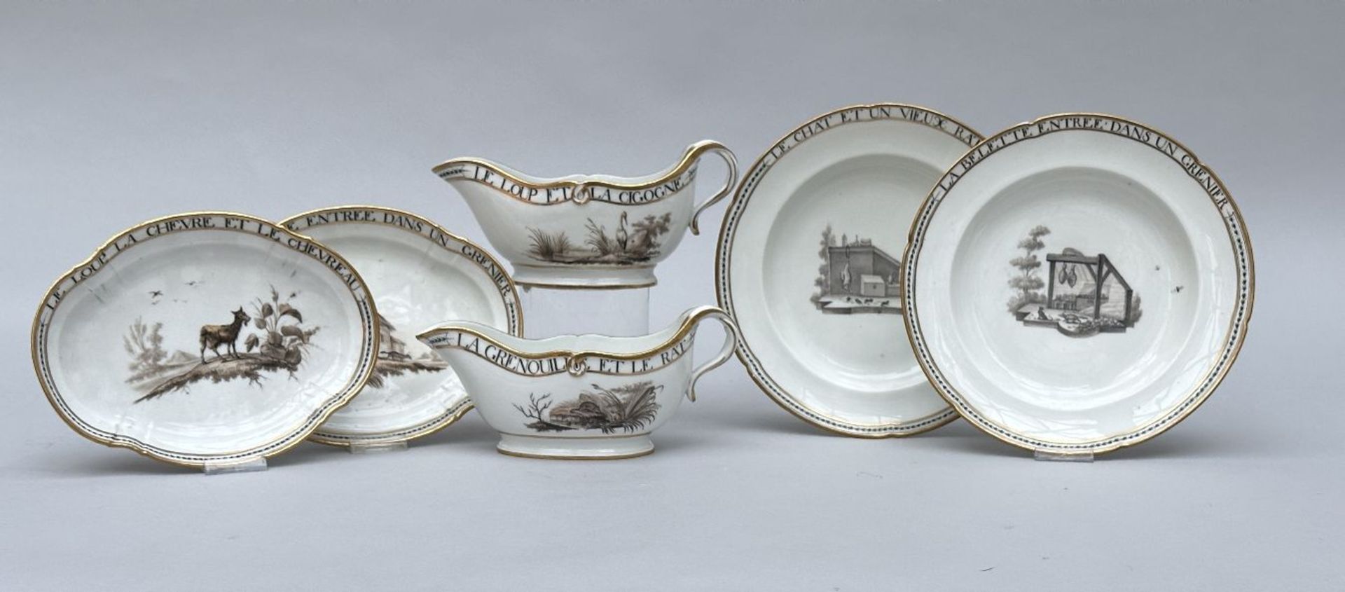 Two plates and two sauce boats in porcelain by Louis Cretté in Brussels 'fables de La Fontaine'