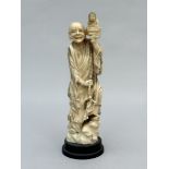 A Japanese Okimono 'Rakan with Buddha sculpture', Meiji period