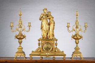 A gilt bronze clock 'ladies' by Houdebine with two candlesticks