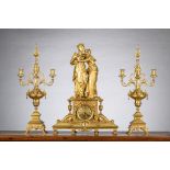 A gilt bronze clock 'ladies' by Houdebine with two candlesticks