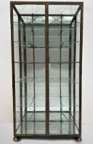 Brass two-door display cabinet with mirror back and bottom (*)