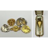 A collection of Art Nouveau jewels: three golden brooches by Van Der Straeten, two silver brooches,