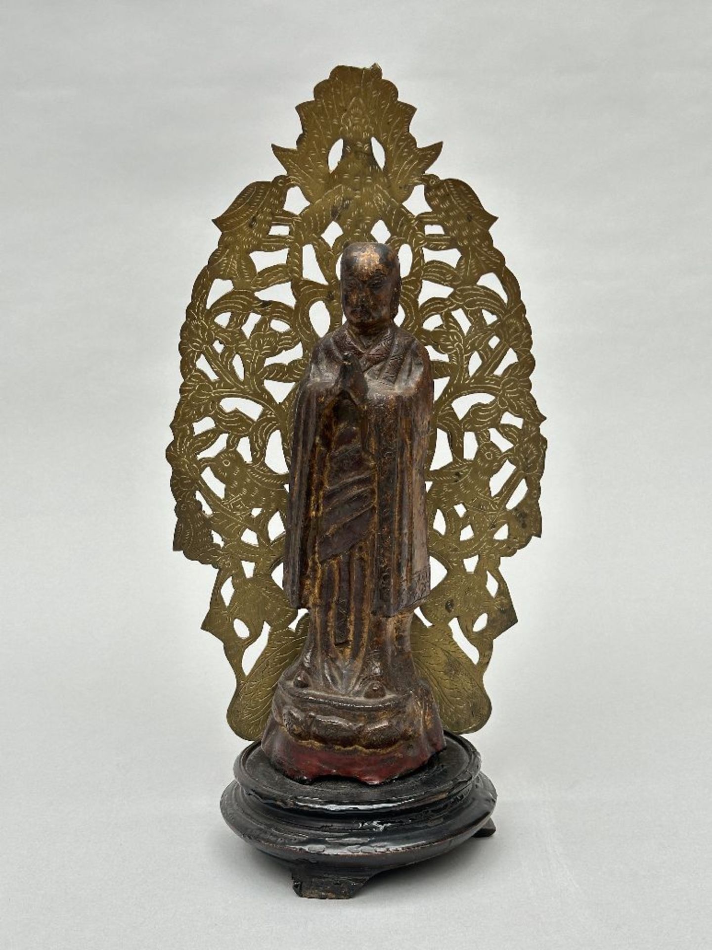 Lacquered bronze statue 'Arhat', late Ming dynasty (mounted on a plinth with copper low relief)