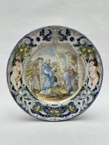 A large Majolica platter with religious scene (*)