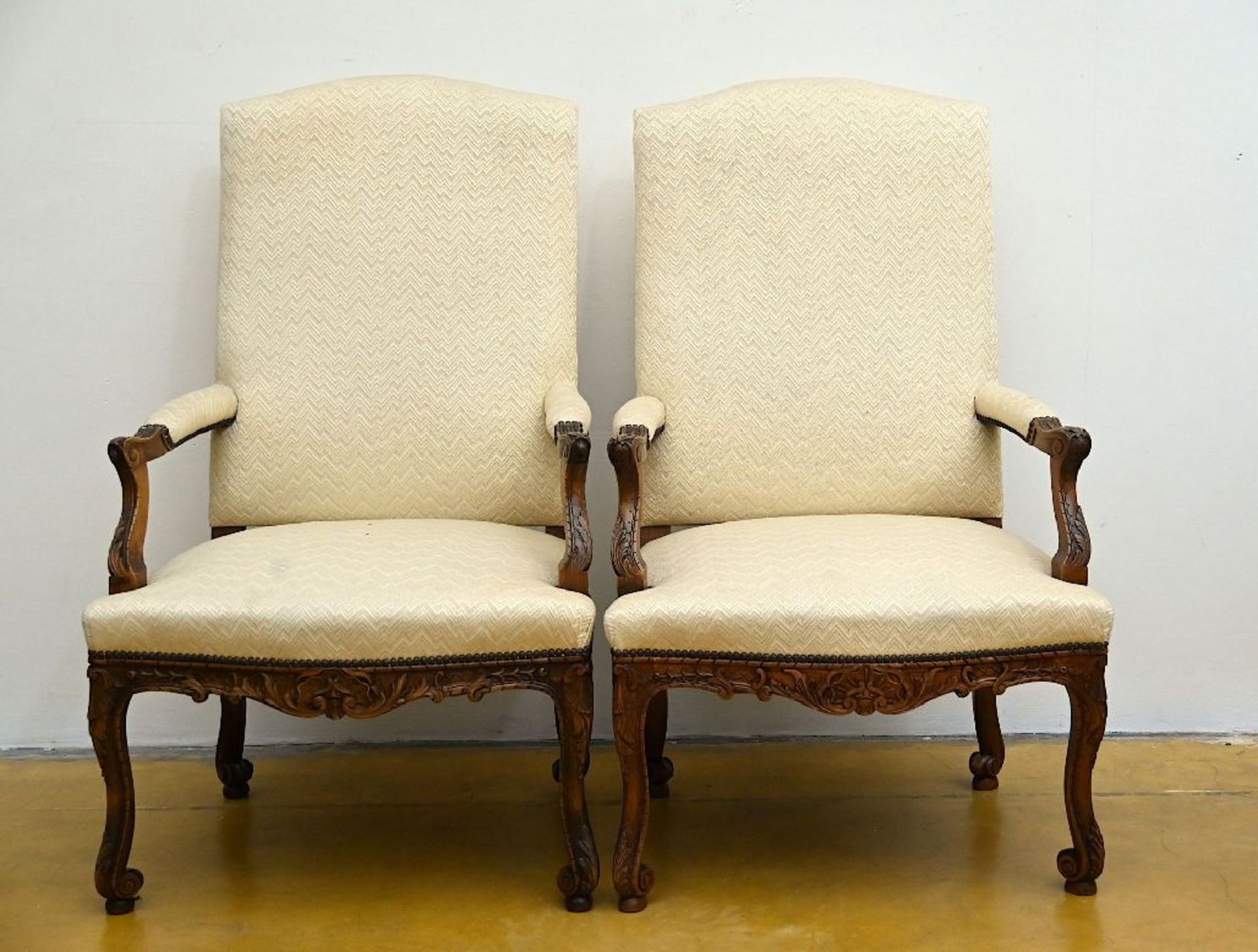 A pair of beech wood armchairs, Regence style