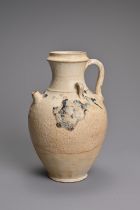 A CHINESE SPLASH GLAZED STONEWARE EWER. Of ovoid form with short spout and twin looped handles to