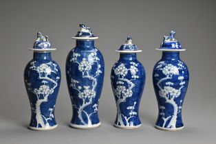 FOUR CHINESE BLUE AND WHITE PORCELAIN PRUNUS VASES AND COVERS, EARLY 20TH CENTURY. Each of tall
