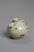 A CHINESE SPOTTED GLAZED PORCELAIN JAR, YUAN DYNASTY. A small globular jar with two looped handles