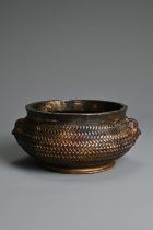A CHINESE GILT AND RED LACQUER BRONZE CENSER. Of squat form with a basket weave exterior and twin