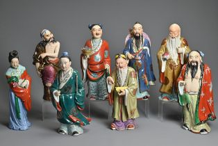 A GROUP OF EIGHT CHINESE POLYCHROME DECORATED PORCELAIN FIGURES, 20TH CENTURY. To include seven