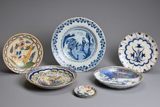 A COLLECTION OF FOUR DUTCH DELFT PLATES AND A NORTH ITALIAN FAIENCE SMALL FLUTED CIRCULAR DISH,