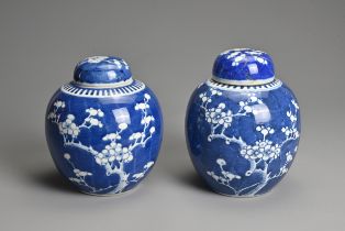 TWO CHINESE BLUE AND WHITE PORCELAIN PRUNUS JARS AND COVERS, 19/20TH CENTURY. Each of globular