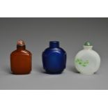 THREE CHINESE GLASS SNUFF BOTTLES. To include an orange square form bottle; A blue semi