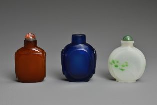 THREE CHINESE GLASS SNUFF BOTTLES. To include an orange square form bottle; A blue semi