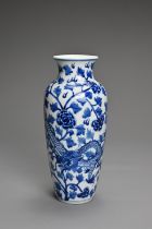 A CHINESE BLUE AND WHITE PORCELAIN VASE. Decorated with a dragon and leafy peony scrolls with flat