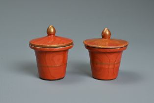 TWO CHINESE CORAL GROUND FAUX BOIS PORCELAIN POTS AND COVERS, 19TH CENTURY. Painted to the