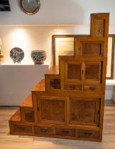 EARLY 20TH CENTURY JAPANESE/KOREAN ELMWOOD STEPPED CABINET, in two sections, top faux drawer above a