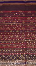 AN INDONESIAN SUMATRAN LAMPUNG CEREMONIAL GOLD THREAD TAPIS SARONG, EARLY 20TH CENTURY.