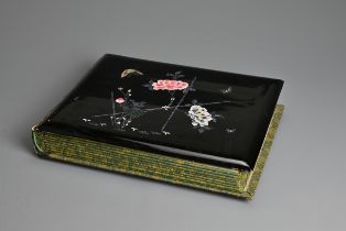 A JAPANESE LACQUER PHOTOGRAPH ALBUM, EARLY 20TH CENTURY. Leather spine with black lacquered covers