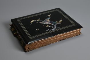 A JAPANESE LACQUER PHOTOGRAPH ALBUM, EARLY 20TH CENTURY. The cover inlaid and painted featuring a